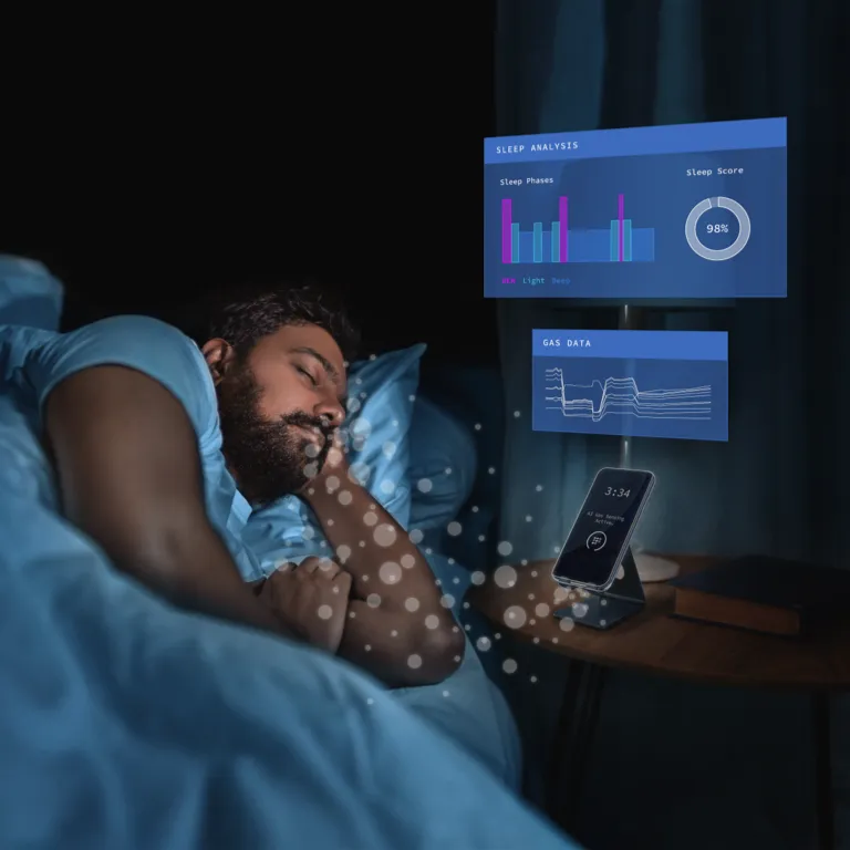 Person sleeping next to a smartphone with integrated gas sensor for sleep tracking
